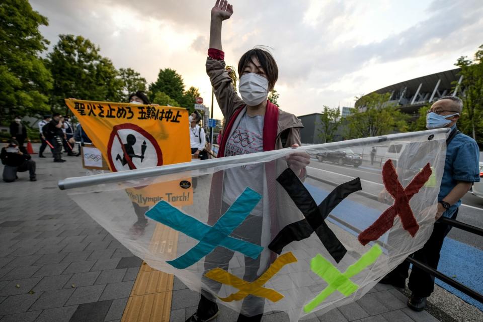 A protester raises a fist while holding a banner