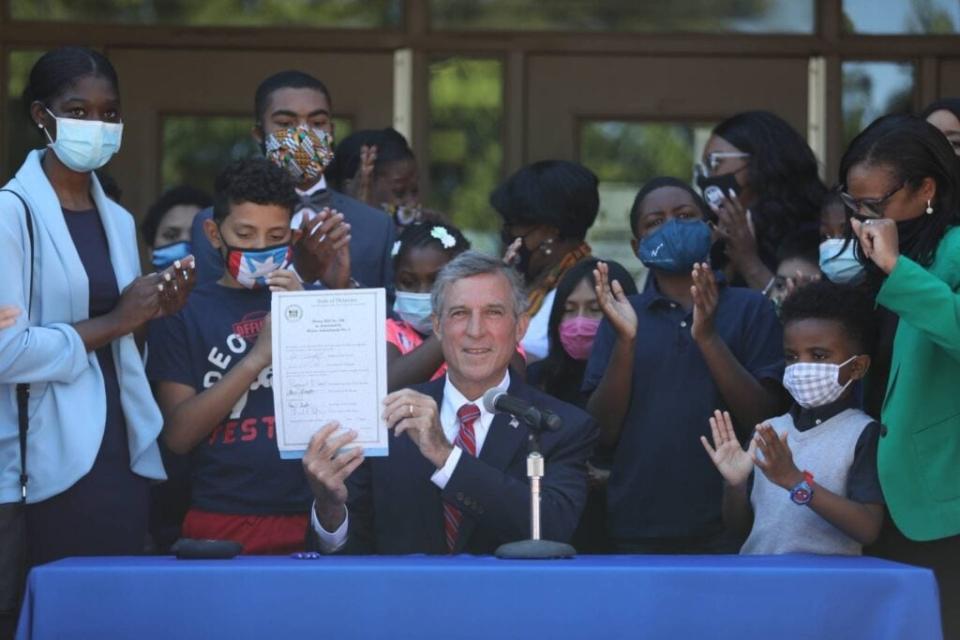 Delaware Governor John Carney signs House Bill 198, the legislation that requires each school district and charter school serving K-12 students to provide instruction on Black history as part of all educational programming beginning in the 2022-23 academic year, into law on June 17, 2021. (Photo Cred: Delaware.gov)