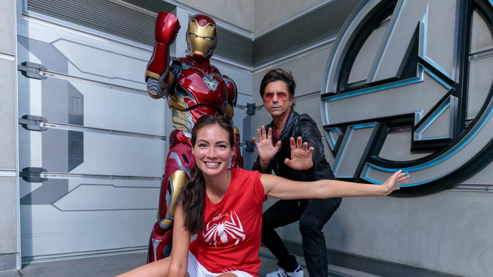 <p>John Stamos and wife Caitlin McHugh meet Iron Man on Aug. 1 at Disney California Adventure Park in Anaheim, California, in celebration of National Spider-Man Day and the season 2 premiere of Stamos' <em>Marvel's Spidey and His Amazing Friends, </em>on which he voices Iron Man. </p>