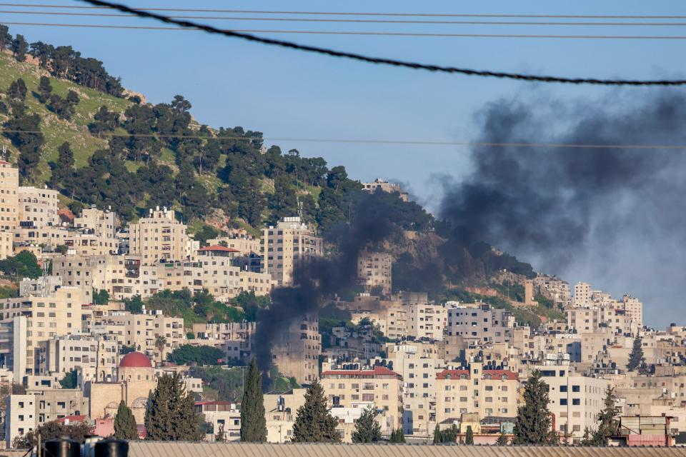 Black smoke billows amid clashes as Israeli forces raid the Balata camp for Palestinian refugees near Nablus city in the occupied West Bank on April 9, 2024; the West Bank has seen a surge in violence to levels unseen in nearly two decades since the Israel-Hamas war in Gaza began on Oct. 7.