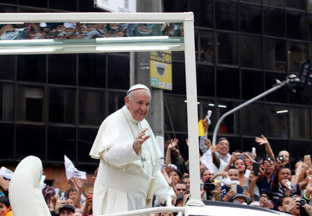 Pope Francis waves to the crowd from the popemobile after visiting an orphanage in Medellin, Colombia in his way to La Macarena stadium, September 9, 2017. REUTERS/Fredy Builes