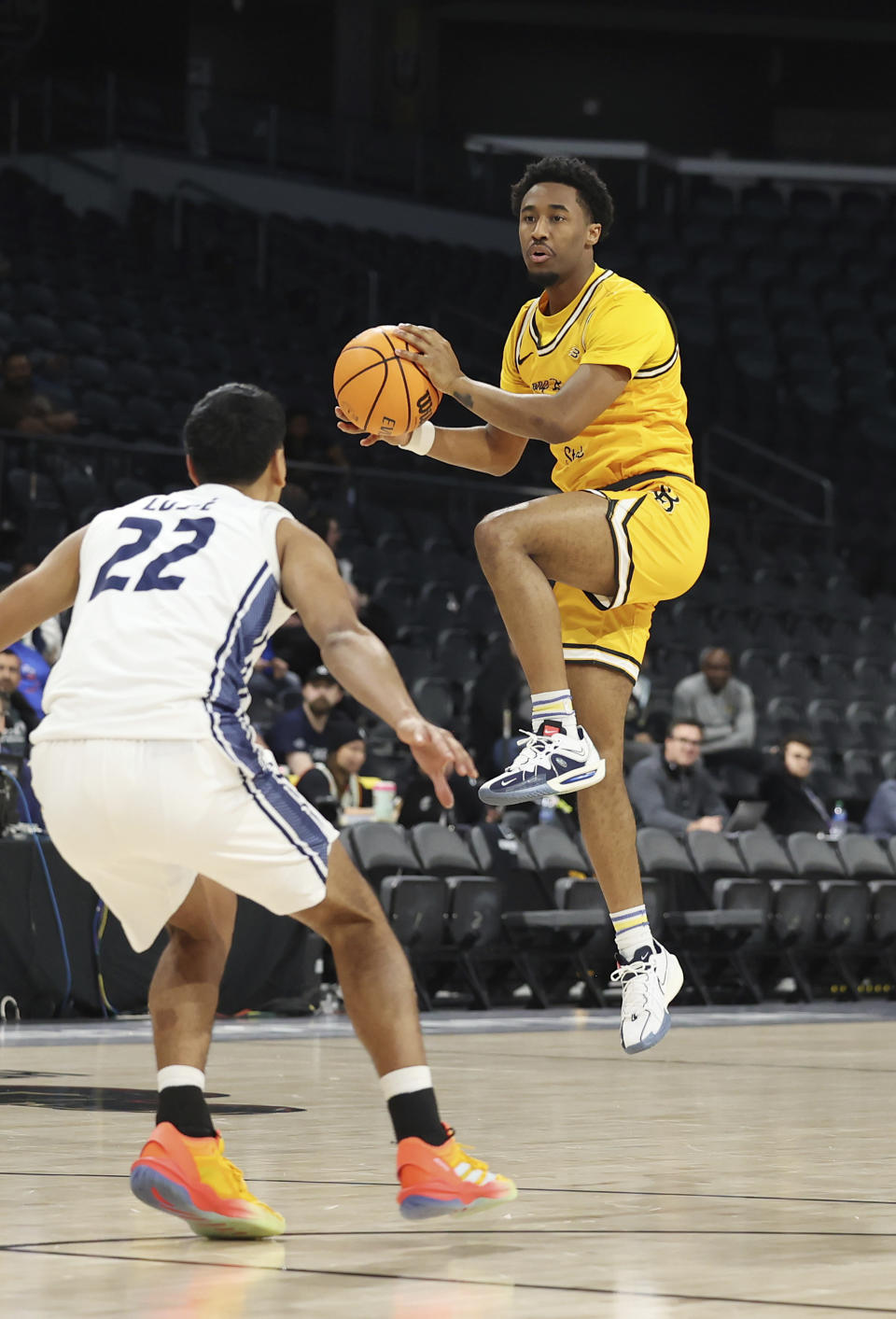 Long Beach State's guard Jason Hart Jr. (5) jumps and grabs a pass near UC Davis guard Sione Lose (22) during the first half of an NCAA college basketball game in the championship of the Big West Conference men's tournament Saturday, March 16, 2024, in Henderson, Nev. (AP Photo/Ronda Churchill)