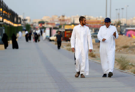 Saudi men walk on a sidewalk in Riyadh, Saudi Arabia September 21, 2017. REUTERS/Faisal Al Nasser