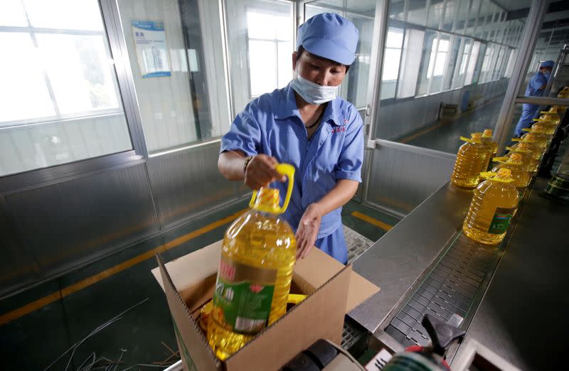 FILE PHOTO: A worker packs bottles of soybean oil made from imported U.S. soybeans at the plant of Liangyou Industry and Trade Co., Ltd in Qufu