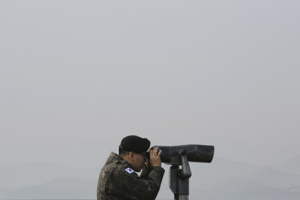 A South Korean army soldier watches the North Korea side from the Unification Observation Post in Paju, South Korea, near the border with North Korea, Wednesday, Dec. 25, 2019. U.S. President Donald Trump said Tuesday that North Korean leader Kim Jong Un may be planning to give him "a nice present" such as a "beautiful vase" for Christmas rather than a missile launch.(AP Photo/Ahn Young-joon)