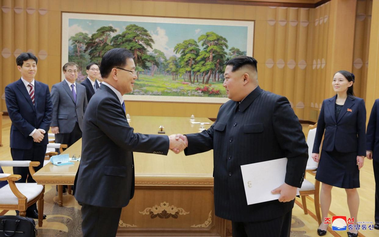 North Korean leader Kim Jong-un shakes hands with a member of the special delegation of South Korea's president - REUTERS