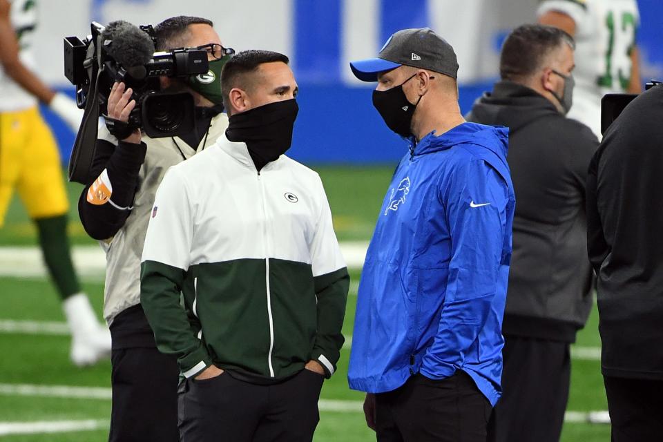 Packers head coach Matt LaFleur talks with Lions interim head coach Darrell Bevell before the game at Ford Field, Dec. 13, 2020.