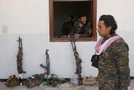 <p>A Kurdish fighter from the People’s Protection Units (YPG) looks out of a window in Raqqa, Syria, June 18, 2017. (Photo: Goran Tomasevic/Reuters) </p>