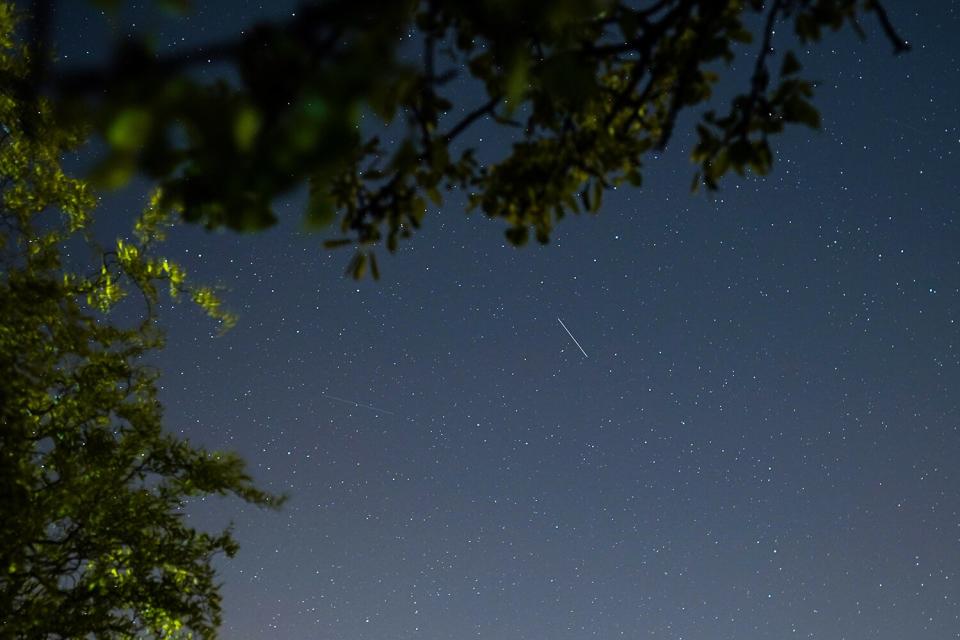 A satellite from a larger group of satellites called Starlink can be seen trailing across the night sky over Saltburn on April 21, 2020 in Saltburn By The Sea, United Kingdom. Starlink is part of the rocket company SpaceX, owned by billionaire CEO Elon Musk. The company aim to create a constellation of 12,000 satellites in the Earth's orbit to improve internet service across the globe.