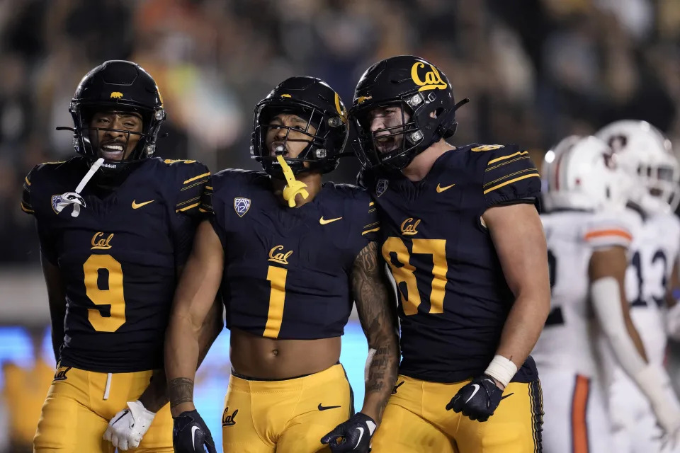 California running back Jaydn Ott (1) celebrates with wide receiver Taj Davis, left, and offensive lineman Tyler Murphy after scoring a touchdown against Auburn during the first half of an NCAA college football game Saturday, Sept. 9, 2023, in Berkeley, Calif. (AP Photo/Godofredo A. Vásquez)