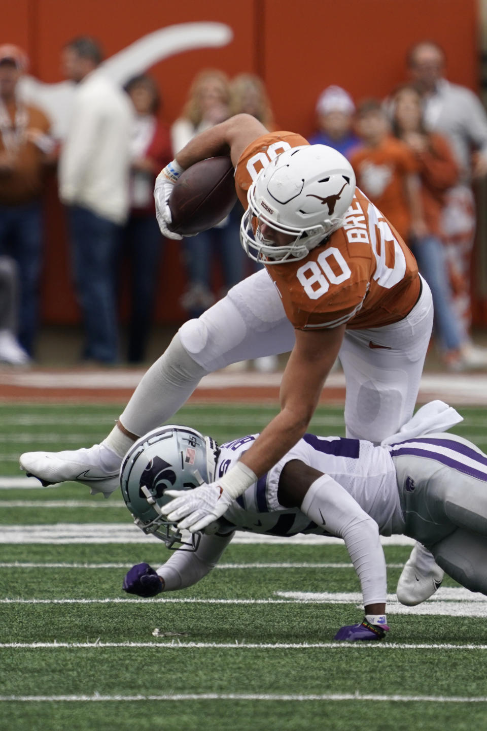 Texas tight end Cade Brewer (80) is upended by Kansas State defensive back Ekow Boye-Doe (25) during the second half of an NCAA college football game in Austin, Texas, Friday, Nov. 26, 2021. (AP Photo/Chuck Burton)