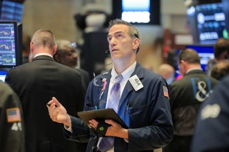 Traders work on the floor at the NYSE in New York