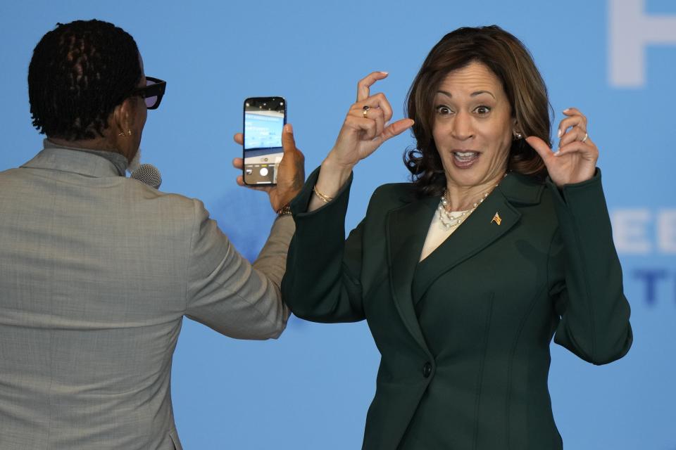 FILE - Vice President Kamala Harris and comedian and author DL Hughley take a selfie with the crowd during an event at Discovery World May 16, 2024, in Milwaukee. (AP Photo/Morry Gash, File)