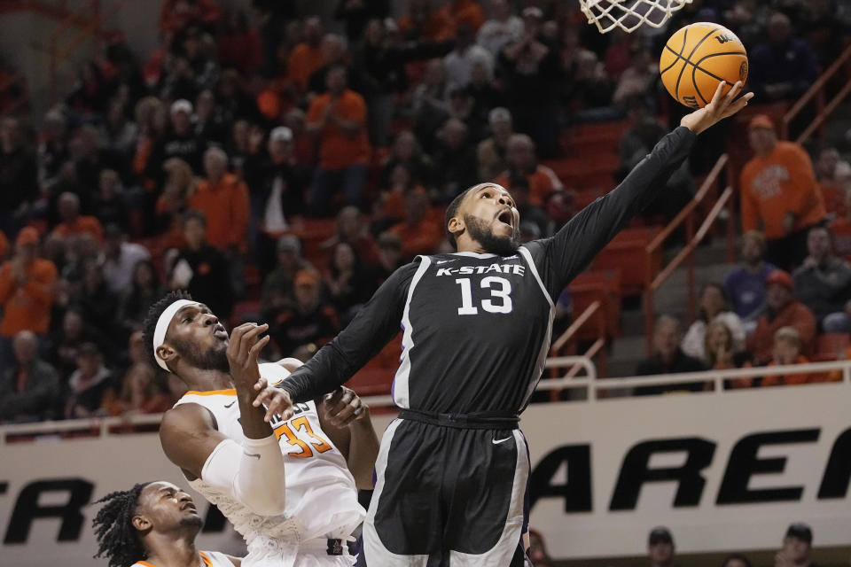 Kansas State guard Desi Sills (13) shoots in front of Oklahoma State forward Moussa Cisse (33) in the first half of an NCAA college basketball game, Saturday, Feb. 25, 2023, in Stillwater, Okla. (AP Photo/Sue Ogrocki)