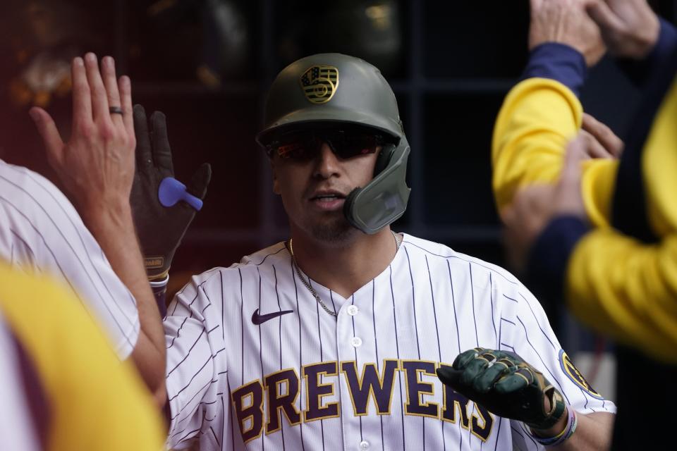 Milwaukee Brewers' Tyrone Taylor is congratulated after hitting a home run during the fifth inning of a baseball game against the Washington Nationals Sunday, May 22, 2022, in Milwaukee. (AP Photo/Morry Gash)