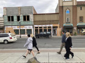 In this Tuesday, Oct. 5, 2021, photo, people walk in the streets undergoing a renewal project to fix decayed buildings downtown The Dalles, Oregon. As demand for cloud computing grows, the world's biggest tech companies are building more data centers, including in arid regions even though they use vast amounts of water per day. Some residents of The Dalles, Oregon, are objecting to a proposal by Google to build more data centers there, fearing that, amid rising temperatures and drought, there won't be enough water for everyone. (AP Photo/Andrew Selsky)