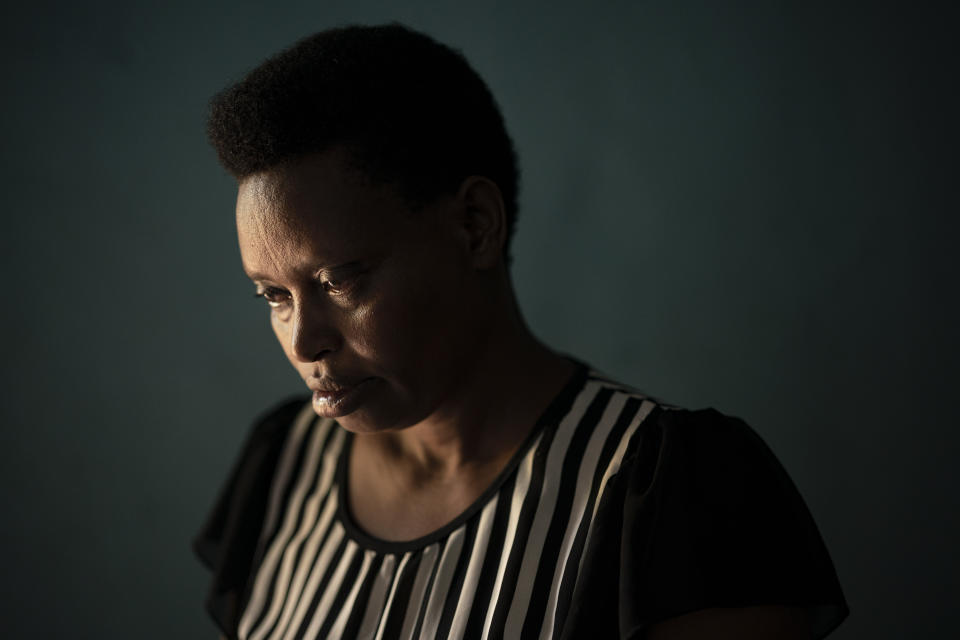 In this Sept. 9, 2019 photo, Alphonsine Umurerwa, reflects after talking about her late daughter Sandrine Umwungeri during a "verbal autopsy" in her home in Kigali, Rwanda. The verbal autopsies now being done in Rwanda rely upon tools developed by Bloomberg Data for Health and approved by the WHO. The same toolset is also being deployed in pilot programs in Tanzania, Zambia, Myanmar, Bangladesh, and a handful of other locations. (AP Photo/Felipe Dana)