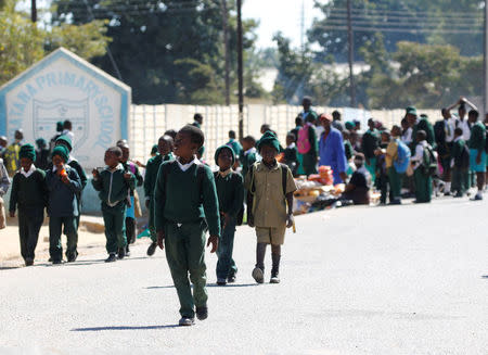 School pupils walk home from Kubatana Primary school in Epworth near Harare, Zimbabwe, July 5, 2016. REUTERS/Philimon Bulawayo