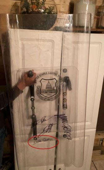 Joshua Doolin of Polk City seized a U.S. Capitol Police officer's riot shield and brought it home as a souvenir, according to federal prosecutors. Doolin and friends signed the shield, seized by FBI agents from the home of Olivia Pollock.