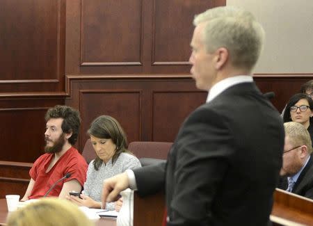 Accused Aurora theater gunman James Holmes (L) listens to Arapahoe County District Attorney George Brauchler (R) at his arraignment in Centennial, Colorado in a March 12, 2013 file photo. REUTERS/R.J. Sangosti/Pool/Files