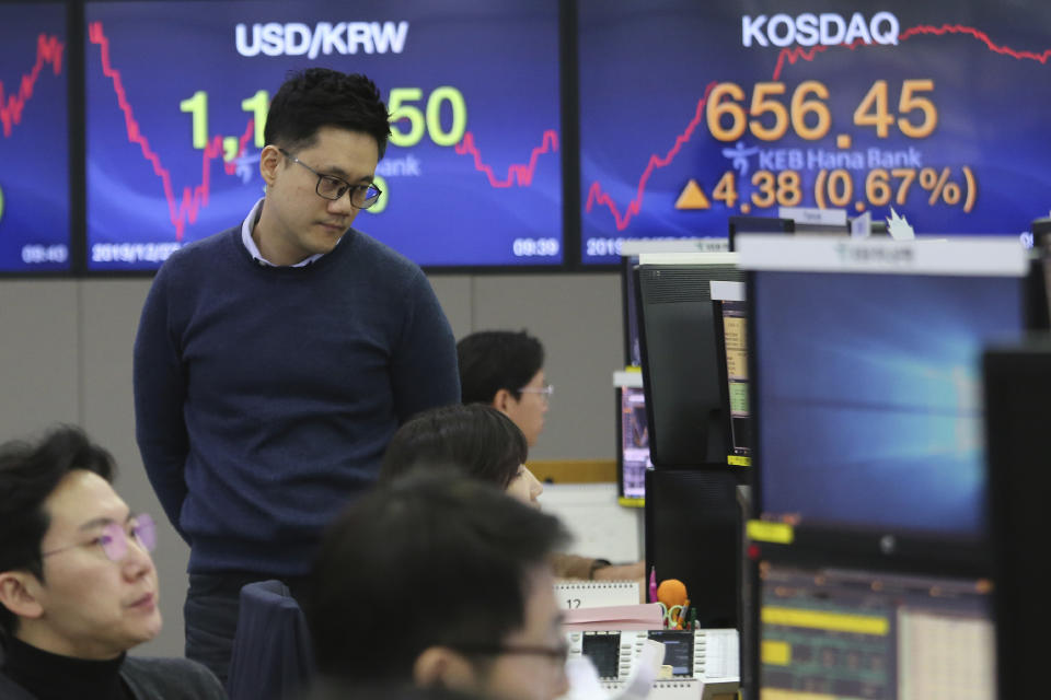 A currency trader watches monitors at the foreign exchange dealing room of the KEB Hana Bank headquarters in Seoul, South Korea, Friday, Dec. 27, 2019. Asian stocks followed Wall Street higher on Friday amid optimism U.S.-Chinese trade relations are improving. (AP Photo/Ahn Young-joon)