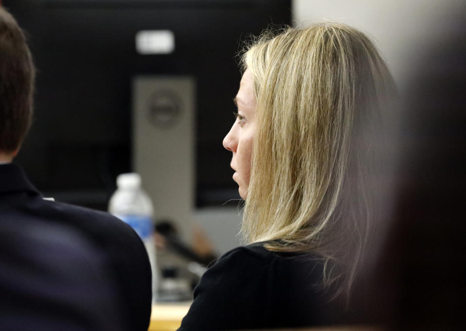 Fired Dallas police officer Amber Guyger listens as friends, family and coworkers speak in her defense during the sentencing phase of her murder trial, Wednesday, Oct. 2, 2019, in Dallas. Guyger, who said she fatally shot her unarmed, black neighbor Botham Jean after mistaking his apartment for her own, was found guilty of murder the day before. (Tom Fox/The Dallas Morning News via AP, Pool)