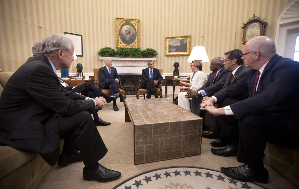 President Barack Obama, center, and Vice President Joe Biden, center left, meet with Democratic Leadership in the Oval Office of the White House, Tuesday, Oct. 15, 2013, in Washington. (AP Photo/Pablo Martinez Monsivais)