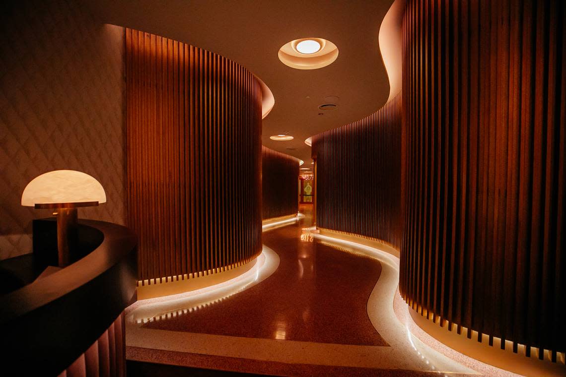 The brass slat passageway to the main dining room at Queen Miami Beach.