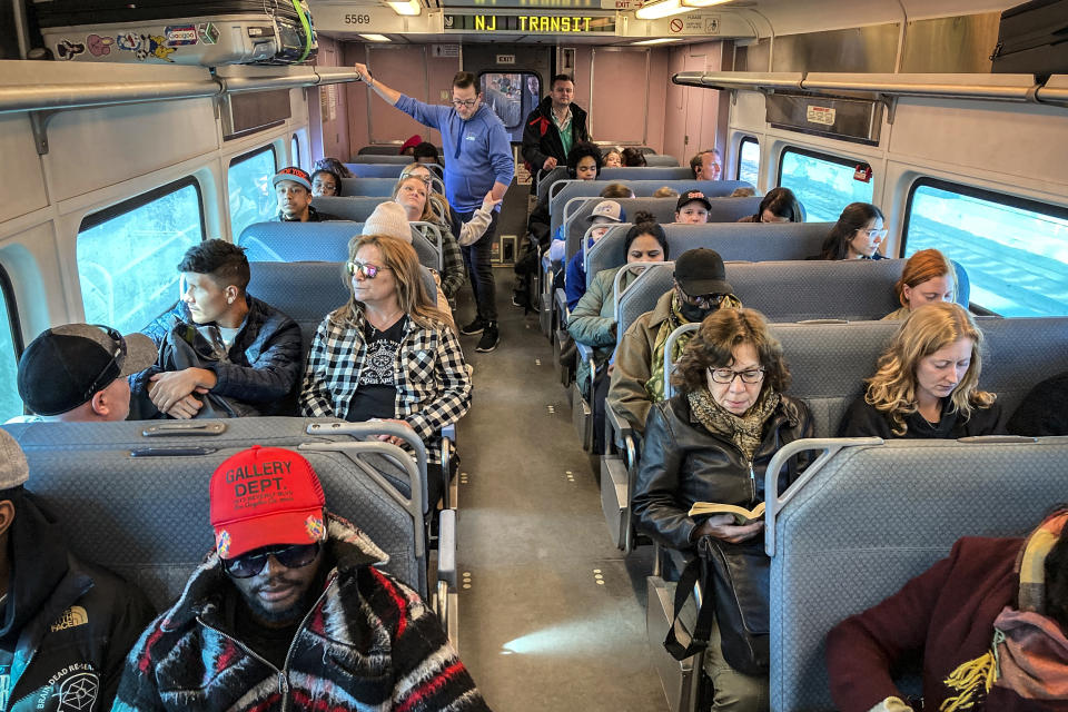 People ride a New Jersey Transit train in Secaucus, N.J., traveling into Penn Station, New York on April 3, 2023. (Ted Shaffrey / AP file)