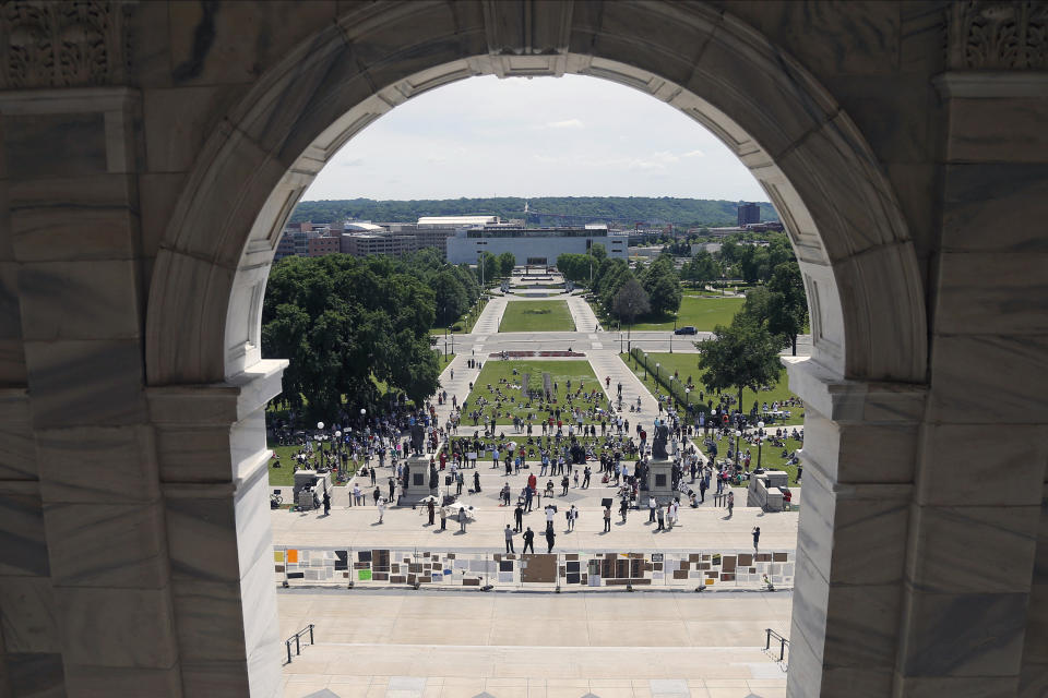 People demonstrate at the Minnesota State Capitol in St. Paul, Minn. on Friday, June 19, 2020, to mark Juneteenth. Juneteenth marks the day in 1865 when federal troops arrived in Galveston, Texas, to take control of the state and ensure all enslaved people be freed, more than two years after the Emancipation Proclamation.(AP Photo/Jim Mone)