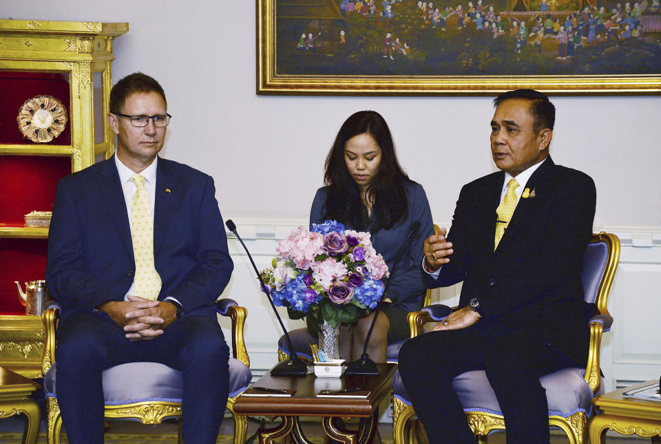 In this photo released by Government Spokesman Office, Richard Harris, left, an Australian member of the Thai cave rescue team, listens to Thailand's Prime Minister Prayuth Chan-ocha, right, during a meeting after receiving the Member of the Most Admirable Order of the Direkgunabhorn during the royal decoration ceremony at the Royal Thai Government House in Bangkok, Thailand, Friday, April 19, 2019. Two Australian doctors, Harris and Craig Challen, received royal honors for helping rescue the Wild Boars soccer team from a flooded cave (Government Spokesman Office via AP)