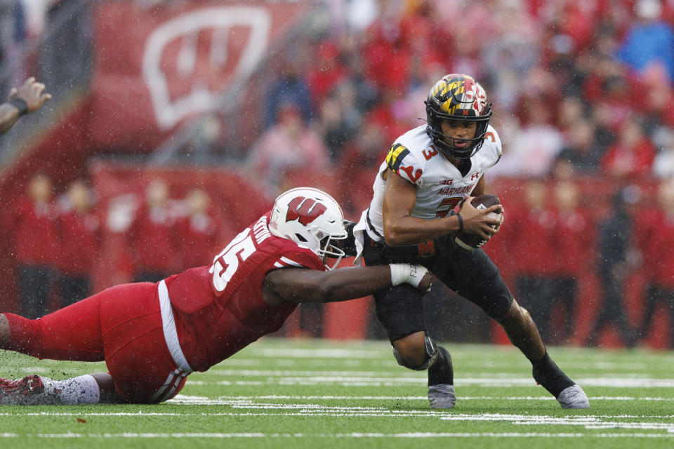 Nov 5, 2022; Madison, Wisconsin, USA; Maryland Terrapins quarterback Taulia Tagovailoa (3) is sacked by Wisconsin Badgers nose tackle Keeanu Benton (95) during the first quarter at Camp Randall Stadium. Mandatory Credit: Jeff Hanisch-USA TODAY Sports