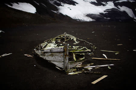 Remains of a boat belonging to an old whaling factory lie on the ground on Deception Island, which is the caldera of an active volcano, in Antarctica, February 17, 2018. REUTERS/Alexandre Meneghini