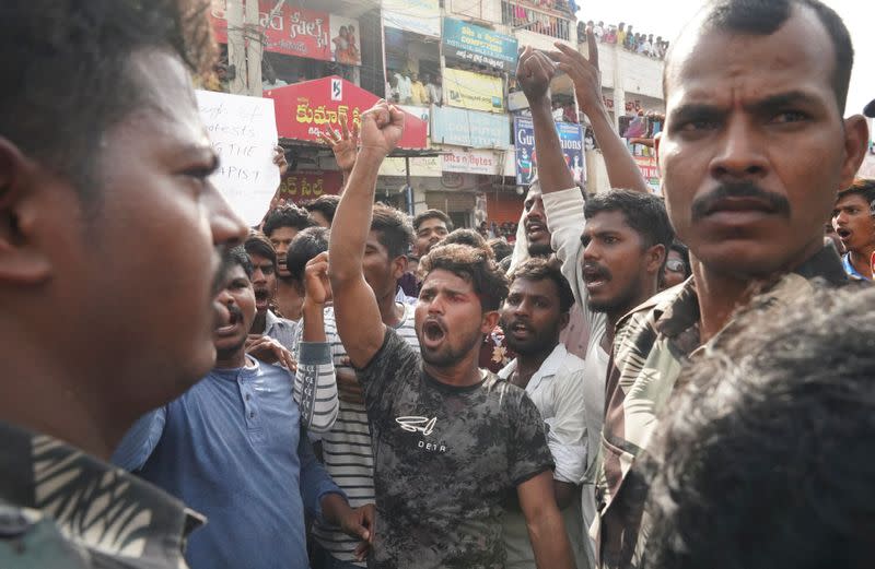 People shout slogans during a protest against the alleged rape and murder of a 27-year-old woman in Shadnagar