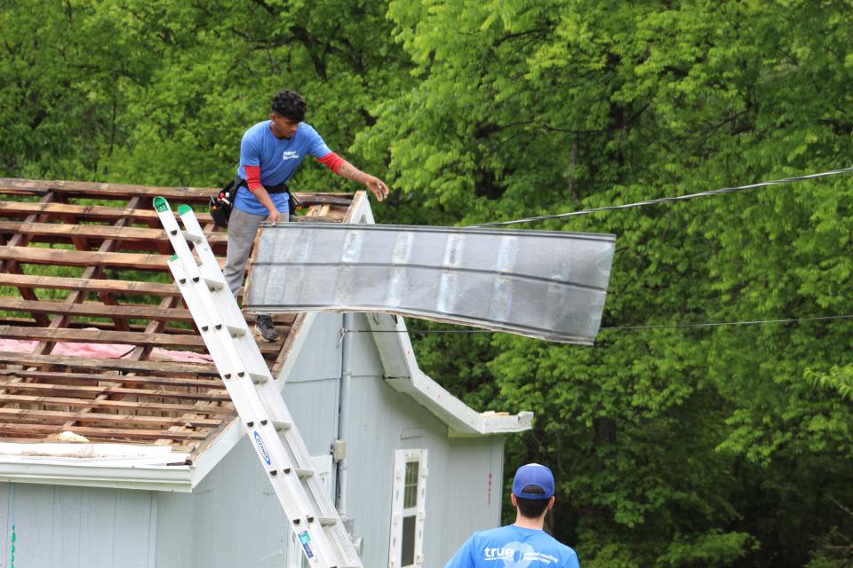 Roofers take off the old roof on Tracie Gamble’s Seymour home. April 24, 2023.