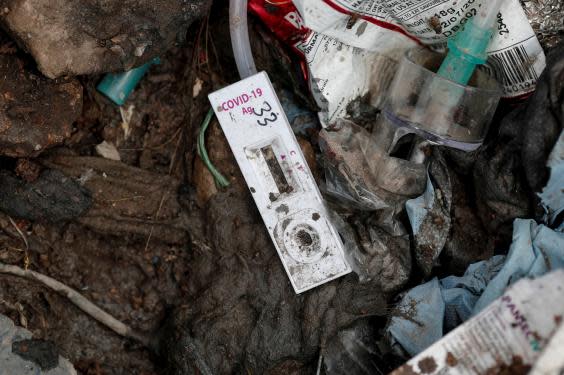 A coronavirus testing kit lies on the floor at the New Delhi landfill site (Reuters)