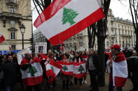 Lebanese protesters gather outside of the French foreign ministry in Paris, Wednesday, Dec. 11, 2019, to denounce a closed-door meeting of diplomats from several countries on aid to Lebanon. The Middle Eastern country is facing a political and economic crisis, and the international group is discussing conditions for global assistance to help ease Lebanon's financial woes.(AP Photo/Francois Mori)