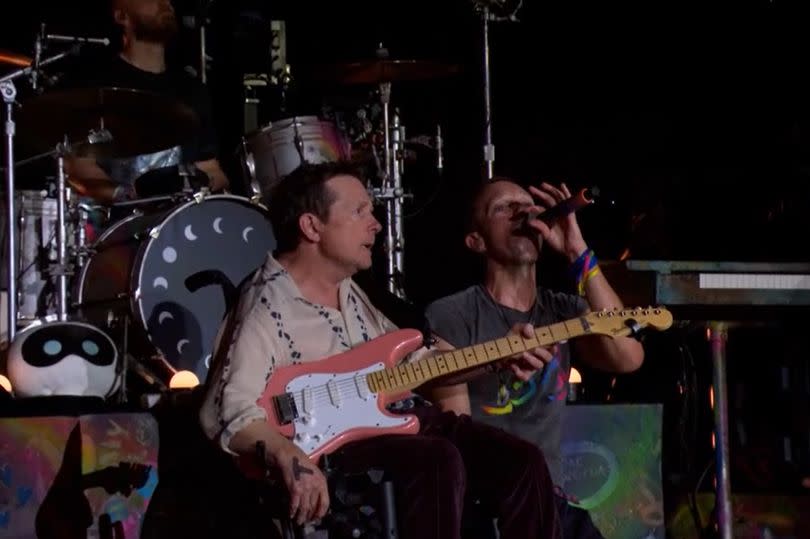 Michael J Fox on stage with Chris Martin