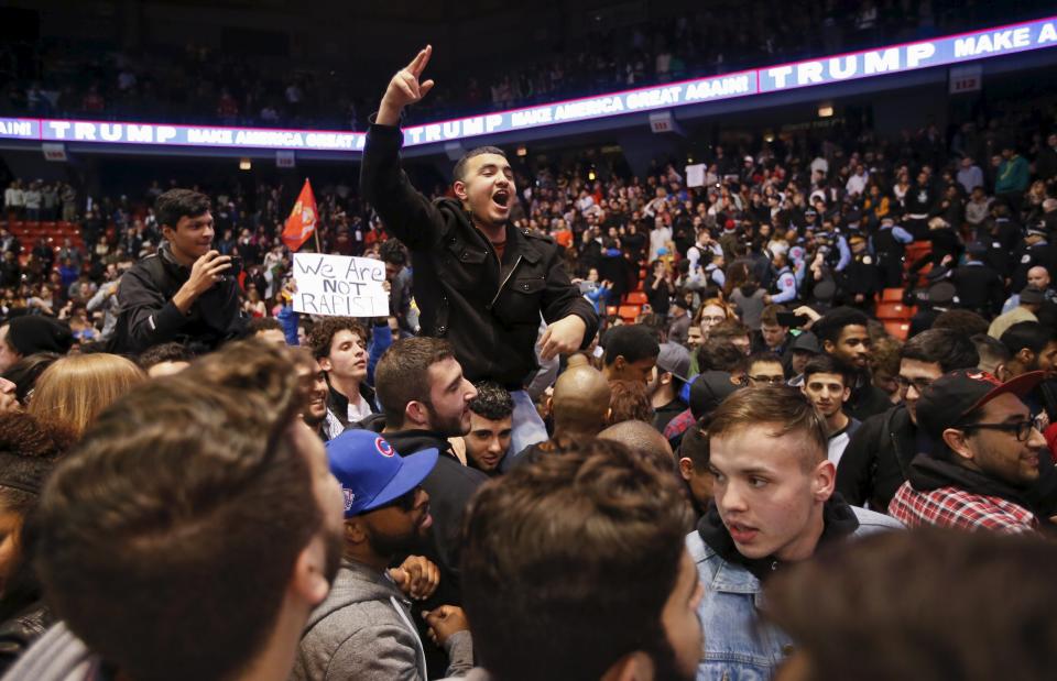 Demonstrators celebrate after Republican U.S. presidential candidate Donald Trump cancelled his rally at the University of Illinois at Chicago March 11, 2016. (REUTERS/Kamil Krzaczynski)