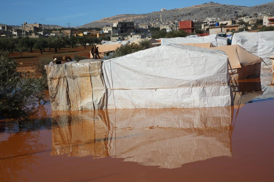 <span class="caption">Refugee camps in Idlib, Syria, flooded in heavy rains, Jan. 31, 2021.</span> <span class="attribution"><a class="link " href="https://www.gettyimages.com/detail/news-photo/heavy-rainstorm-flood-syrian-refugee-camps-in-idlib-syria-news-photo/1230888430?adppopup=true" rel="nofollow noopener" target="_blank" data-ylk="slk:Muhammad al-Rifai/NurPhoto via Getty Images;elm:context_link;itc:0;sec:content-canvas">Muhammad al-Rifai/NurPhoto via Getty Images</a></span>