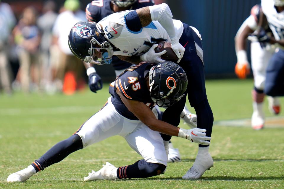 Tennessee Titans wide receiver Gavin Holmes is tackled by Chicago Bears cornerback Bralen Trahan (45) during the second half of an NFL preseason football game, Saturday, Aug. 12, 2023, in Chicago. (AP Photo/Erin Hooley)