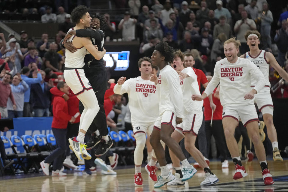 Dayton guard Koby Brea, left, celebrates with teammates following their first-round college basketball game against Nevada in the NCAA Tournament in Salt Lake City, Thursday, March 21, 2024. (AP Photo/Rick Bowmer)