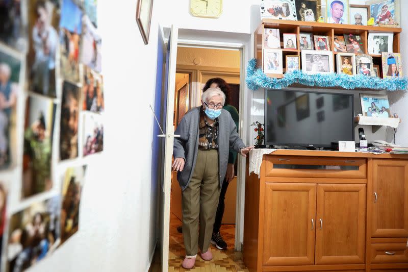 Florentina Martin, a 99 year-old woman who survived coronavirus disease (COVID-19), enters a room at her home in Pinto