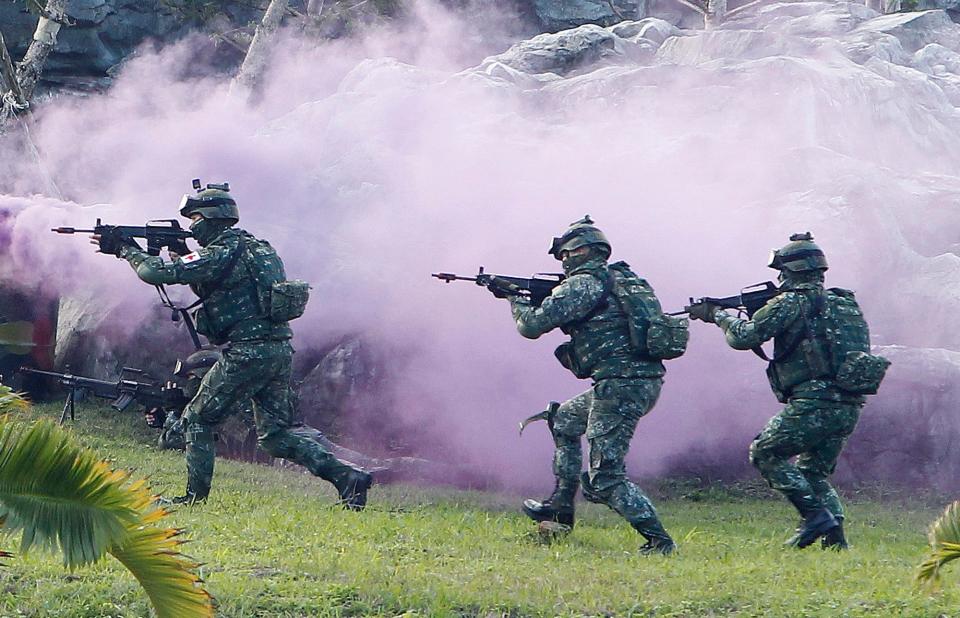 Taiwan's special forces move through colored smoke during a military exercise in Taipei.