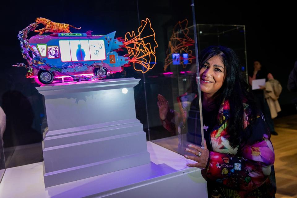 Liverpool-born artist Chila Kumari Singh Burman with her work The Smile You Send Returns To You (Aaron Chown/PA) (PA Wire)