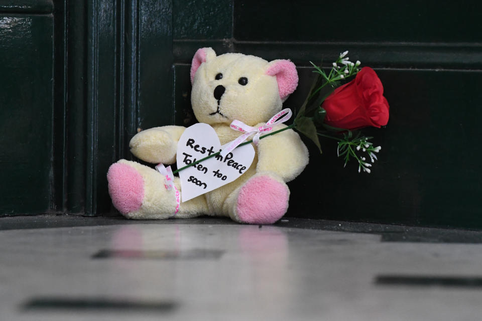 A tribute is seen outside the apartment where Michaela Dunn was found dead.