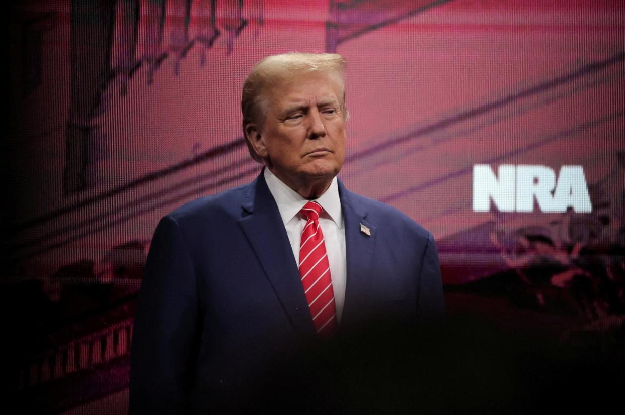 <span>Donald Trump attends the annual NRA meeting in Dallas, Texas, on 18 May 2024.</span><span>Photograph: Carlos Barría/Reuters</span>