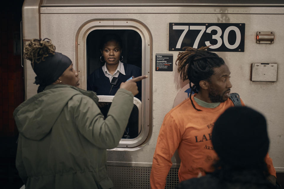 People talk to the train engineer as trains from Manhattan to Brooklyn get cancelled due to heavy rain on Friday, Sept. 29, 2023, in New York. (AP Photo/Andres Kudacki)