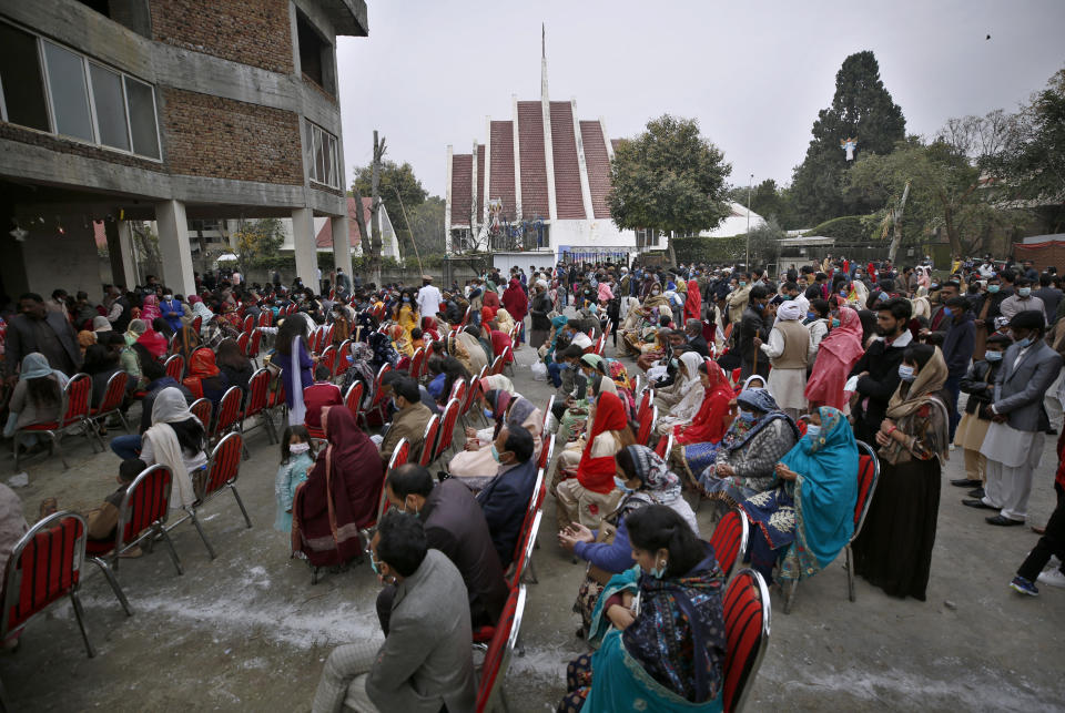 Christians, wearing face masks, attend a Christmas mass in Our Lady of Fatima Church in Islamabad, Pakistan, Friday, Dec. 25, 2020. (AP Photo/Anjum Naveed)