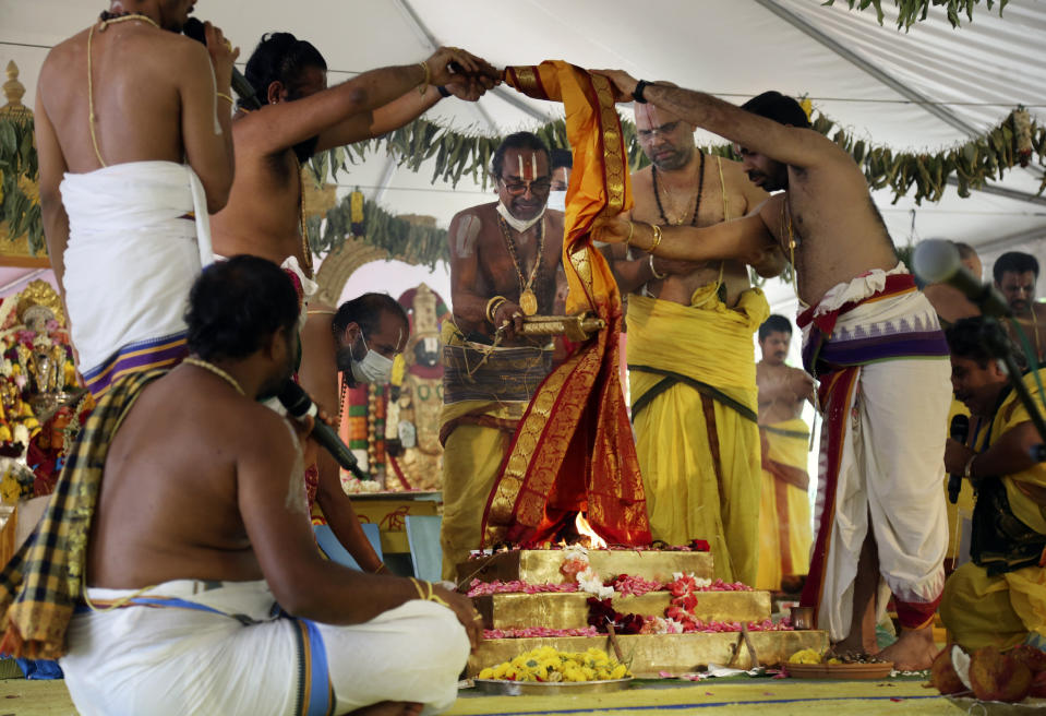 Sri Venkateswara Temple head priest Samudrala Venkatacharyulu, center, leads the Maha Kumbhabhishekam rituals on the fifth and final day of the Hindu rededication ceremony in Penn Hills, Pa., Sunday, June 27, 2021. (AP Photo/Jessie Wardarski)